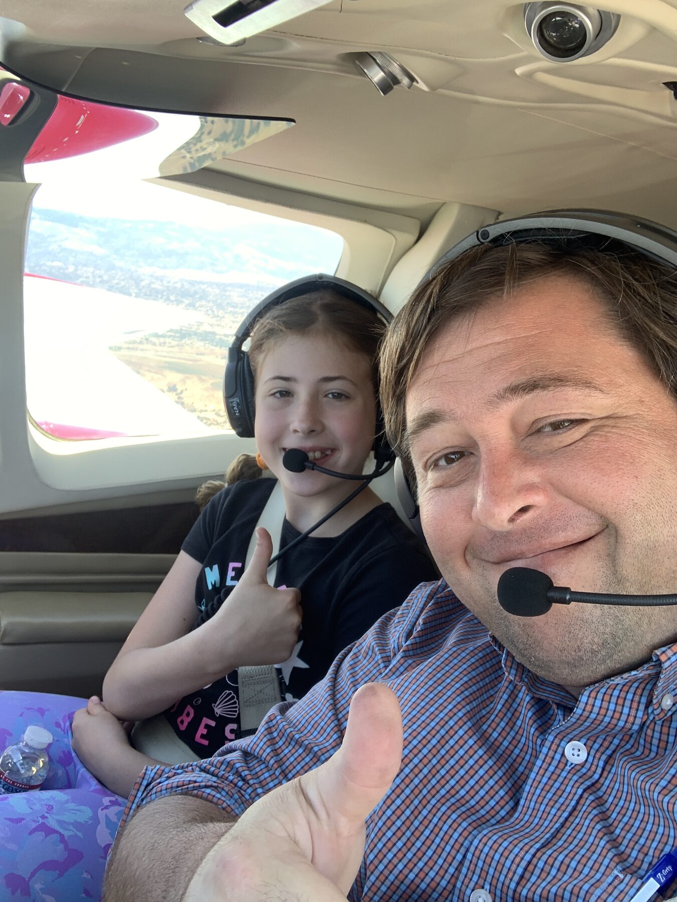 A young flyer at the controls with the instructor