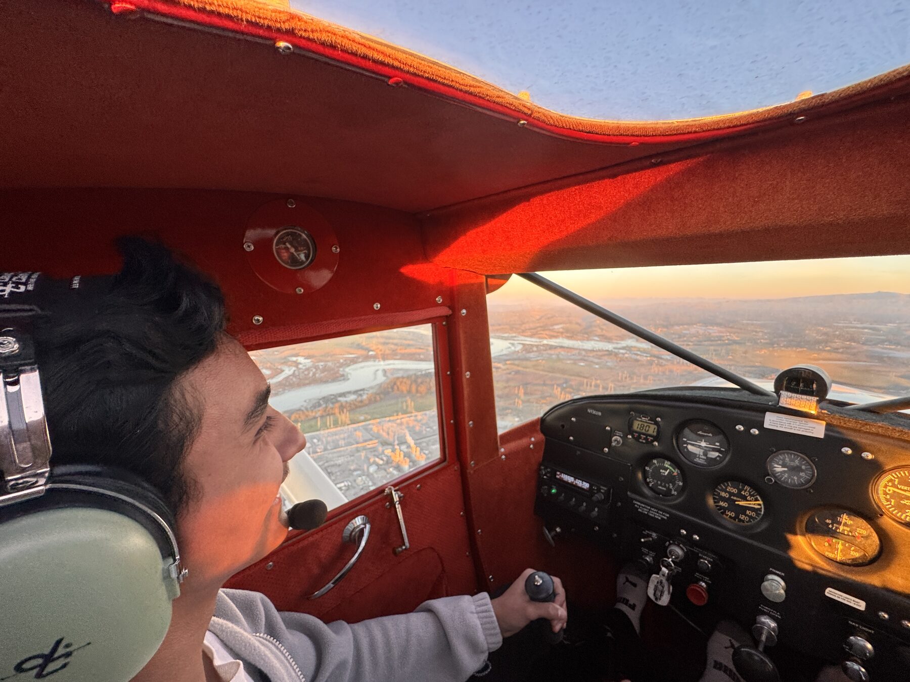 Student flying the Luscombe at sunset