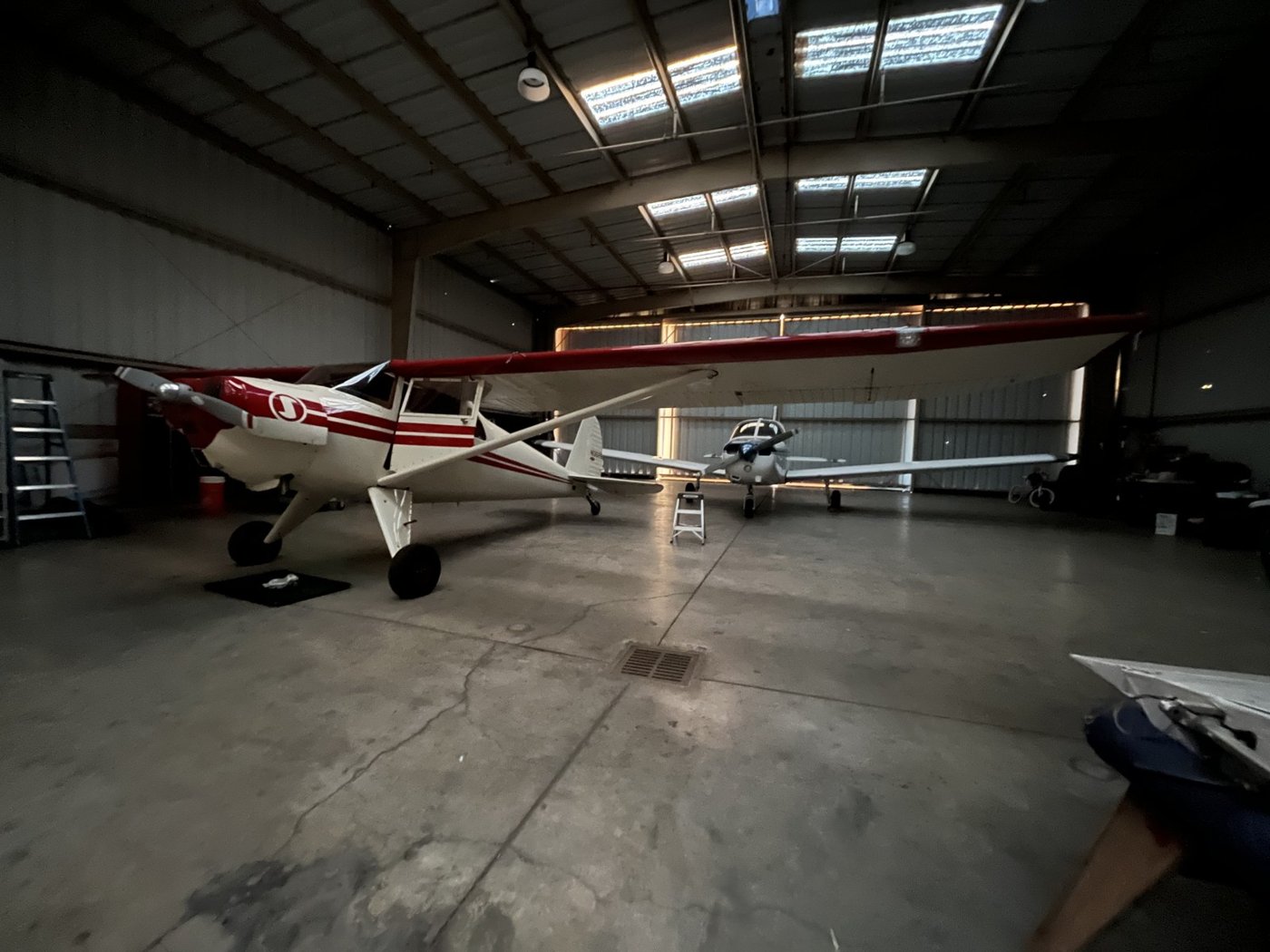 A taildragger parked in a hangar