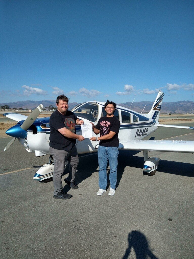 Gabriel and his North Aero instructor holding a certificate in front of the Warrior N41459 at Salinas.