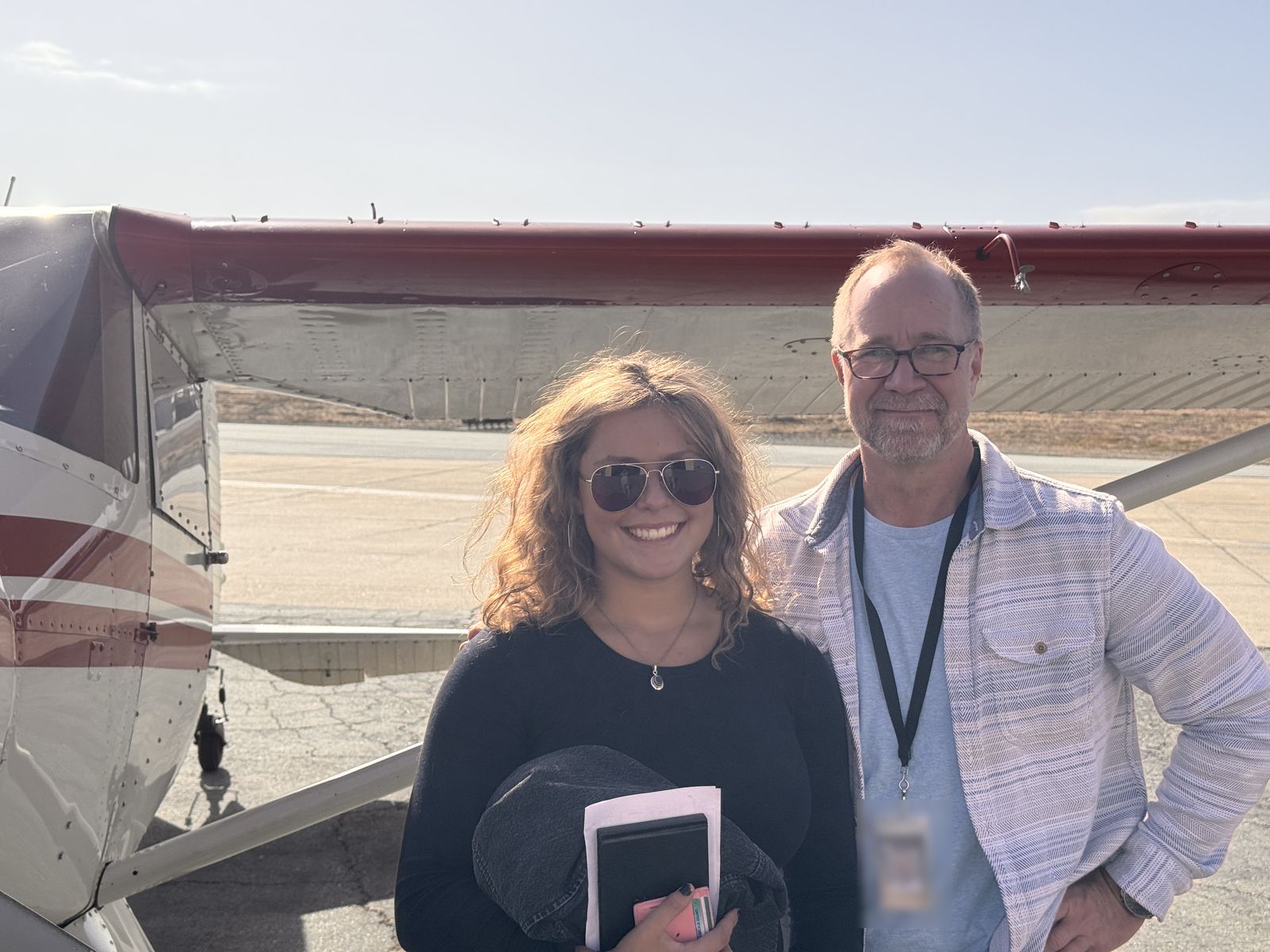 Hadley and her dad, Jeff, standing in front of the Luscombe's wing.