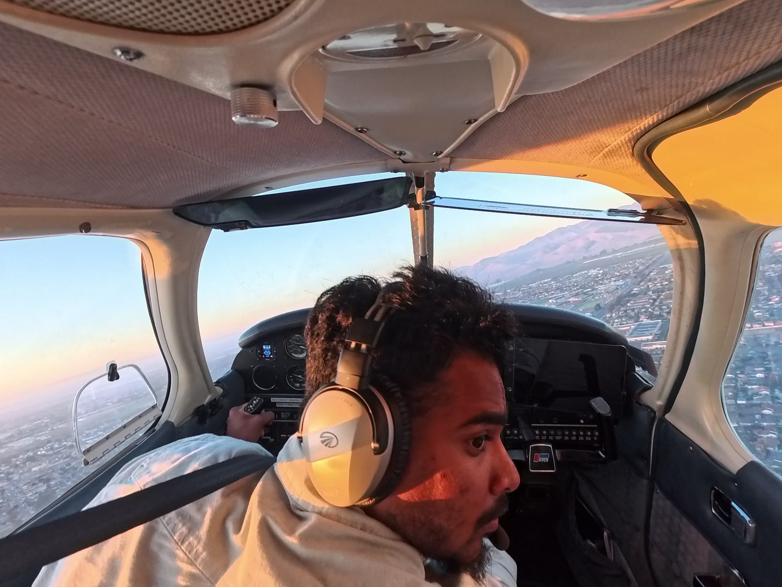 Nazeem at the controls of the Warrior in the traffic pattern, with Salinas below.