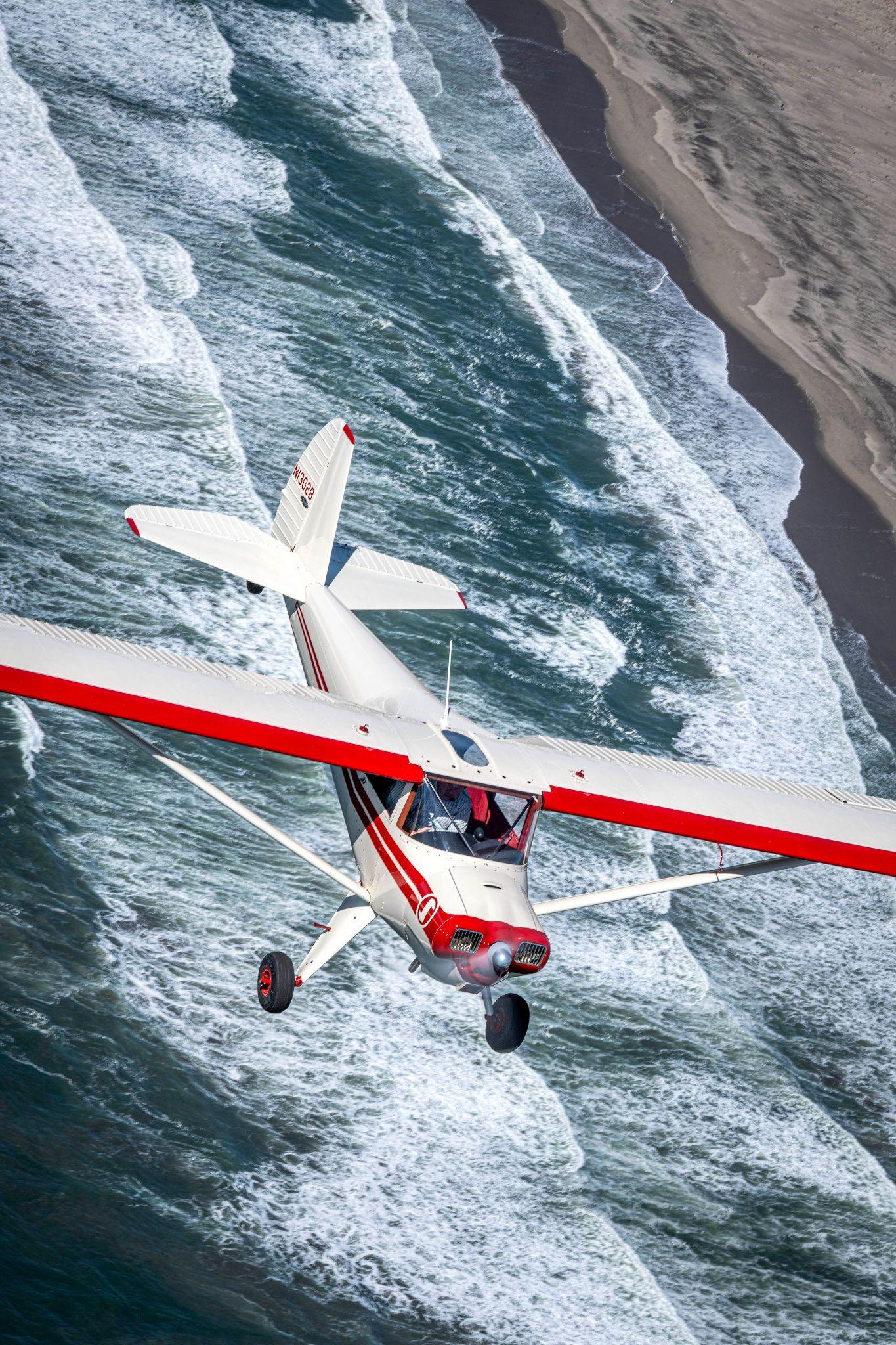 Tailwheel airplane over beach